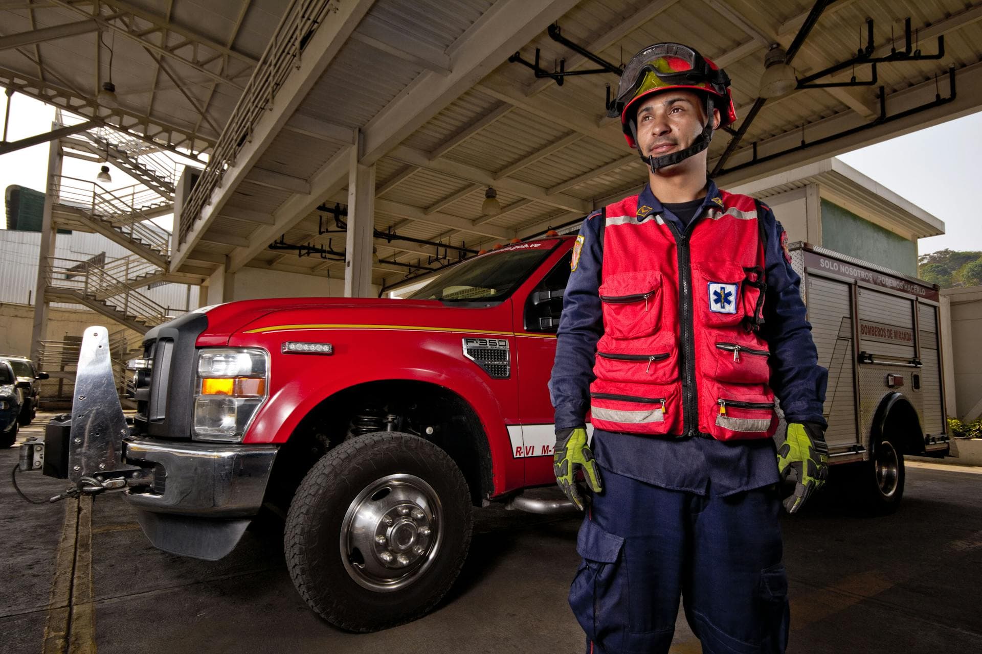 Firefighter in front of firetruck